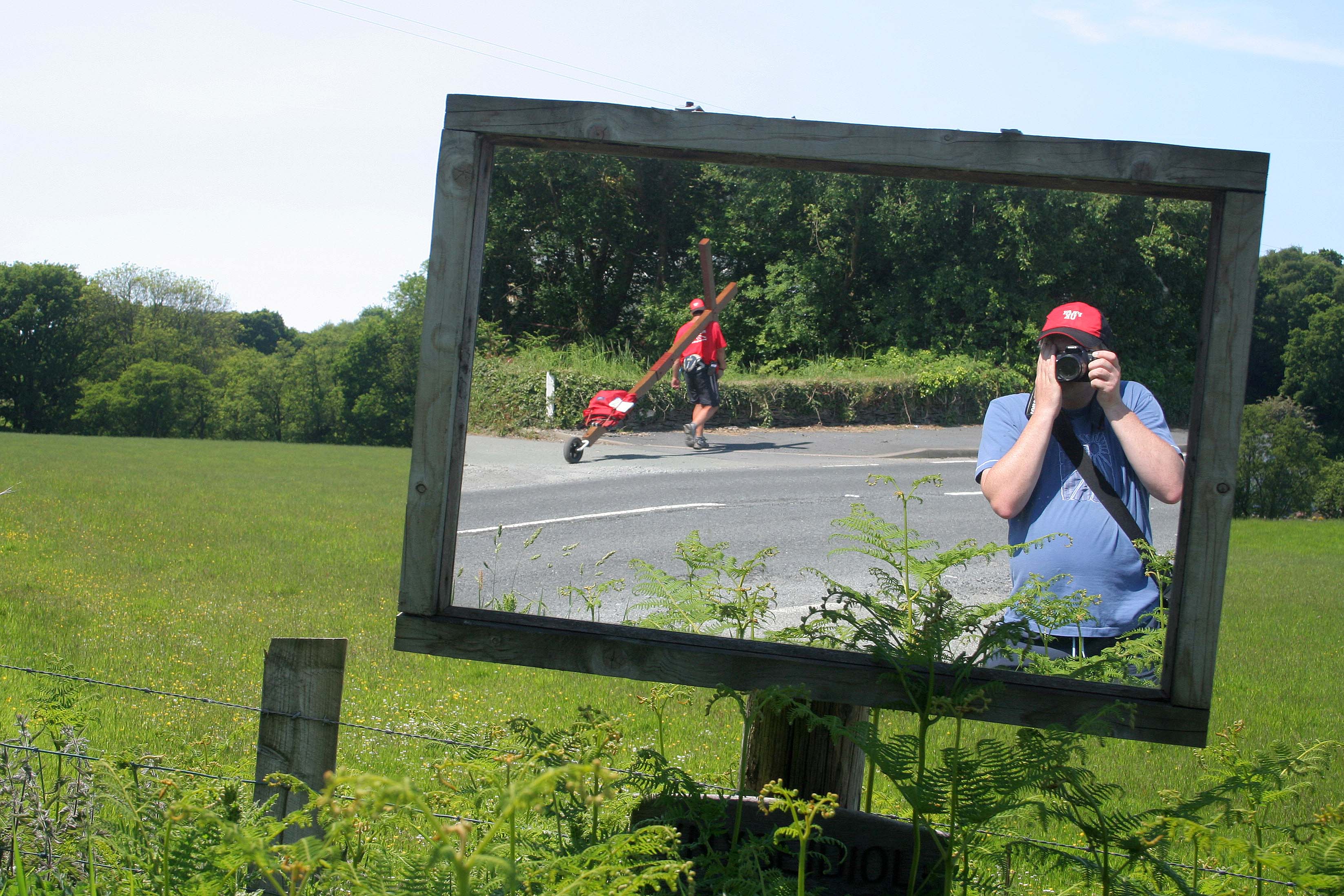 Counties evangelist Clive Cornish captured walking his cross in a roadside mirror - somewhere in mid-Wales