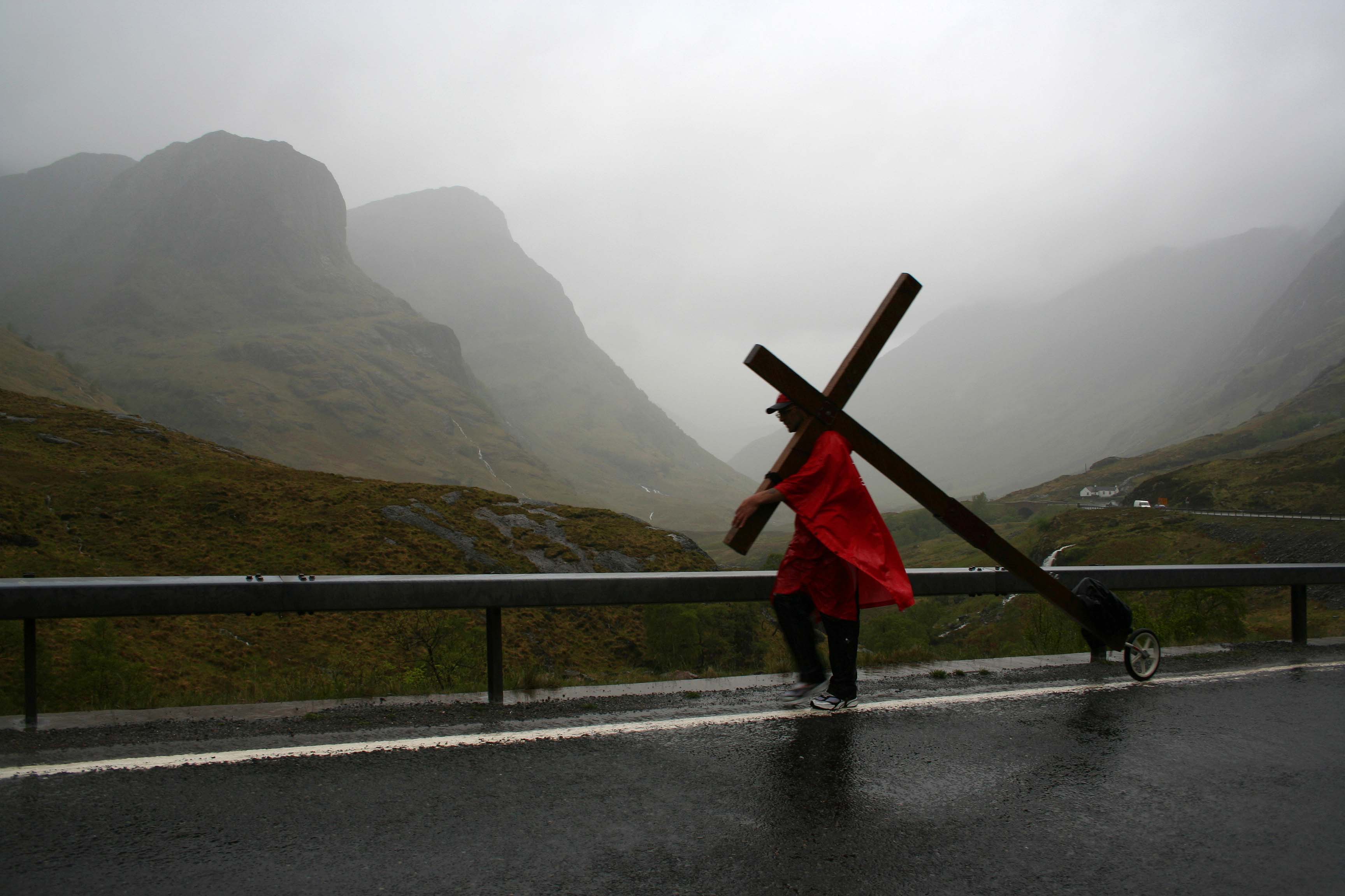 Counties evangelist Clive Cornish walks with his cross through a very wet Glencoe - he passed through Glencoe while walking from John O'Groats to Land's End