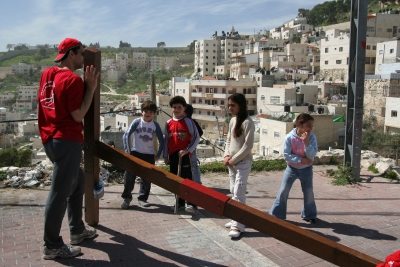 Counties evangelist Clive Cornish climbs the Mount of Olives outside Jerusalem with his cross. Local children come and speak during a project called From Jerusalem to Rome in the Footsteps of the Apostle Paul. Counties evangelist Clive Cornish climbs the Mount of Olives outside Jerusalem with his cross. Local children come and speak during a project called From Jerusalem to Rome in the Footsteps of the Apostle Paul.
