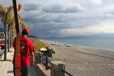 Counties evangelist Clive Cornish see Italy across the Medina Straits as he walks with his cross along the Sicilian coast – photographed during a project called From Jerusalem to Rome in the Footsteps of the Apostle Paul. Counties evangelist Clive Cornish see Italy across the Medina Straits as he walks with his cross along the Sicilian coast - photographed during a project called From Jerusalem to Rome in the Footsteps of the Apostle Paul.