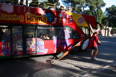 Passengers on a Rome tourist bus stare at Counties evangelist Clive Cornish as he walks in to Rome – photographed during a project called From Jerusalem to Rome in the Footsteps of the Apostle Paul. Passengers on a Rome tourist bus stare at Counties evangelist Clive Cornish as he walks in to Rome - photographed during a project called From Jerusalem to Rome in the Footsteps of the Apostle Paul.