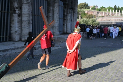 A Roman soldier walks with Counties evangelist Clive Cornish outside the Coliseum in Rome – photographed during a project called From Jerusalem to Rome in the Footsteps of the Apostle Paul. A Roman soldier walks with Counties evangelist Clive Cornish outside the Coliseum in Rome - photographed during a project called From Jerusalem to Rome in the Footsteps of the Apostle Paul.
