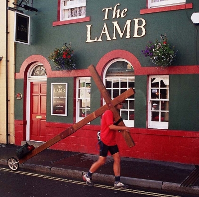 Counties evangelist Clive Cornish walking the cross by The Lamb pub in Builth Wells, Wales