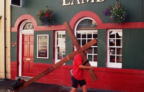 Counties evangelist Clive Cornish walking the cross by The Lamb pub in Builth Wells, Wales