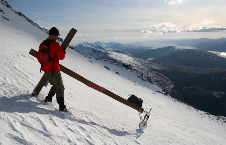 Counties evangelist Clive Cornish climbing Ben Nevis, Britain's highest mountain, in deep snow with his cross
