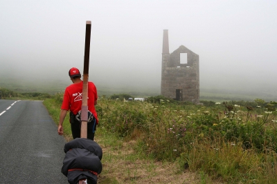 Counties evangelist walks with his cross towards a ruined tin mine in Cornwell - the tin mine looms out of the mist