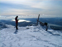 Counties evangelist stops with his cross near the snowy summit of Ben Nevis and enjoys a sweeping mountain view