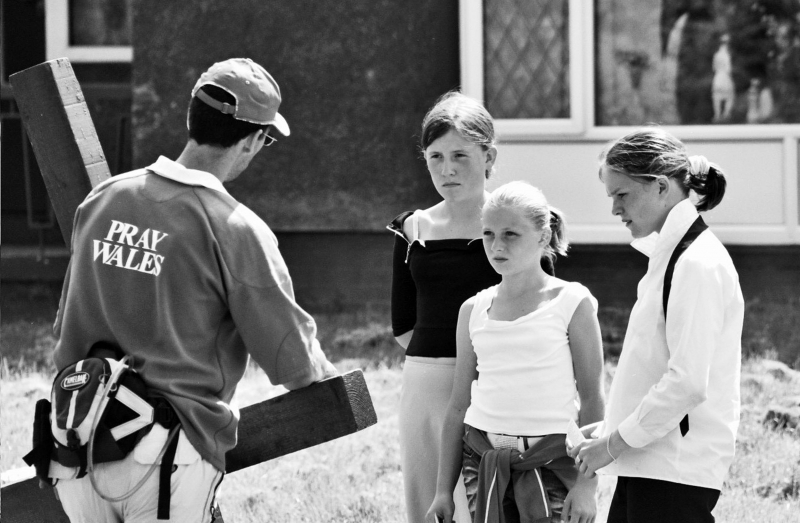 Children talk to Clive as he walks with his cross through the Valleys in South Wales. During a guided pilgrim walk.