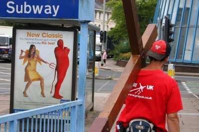 Temptation poster - the devil challenges Counties evangelist Clive Cornish as he walks past a poster near a subway entrance in Exeter